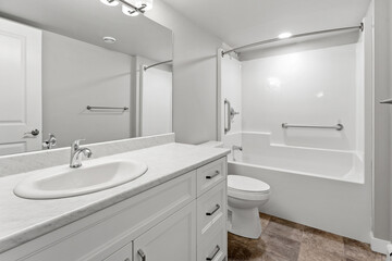 Bathroom with a white sink, toilet, and bathtub