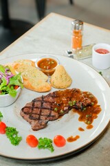 A Delicious steak is served with side dishes, promising a satisfying culinary experience. The image evokes an appetite for a gourmet meal