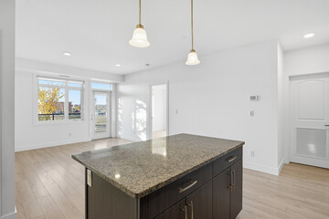 Kitchen with a granite countertop and a white refrigerator