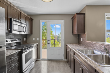 Kitchen with a stainless steel sink and a white stove