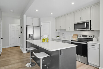 Kitchen with a white island and stainless steel appliances