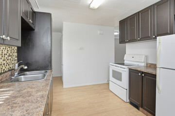 Kitchen with a white stove and a black refrigerator