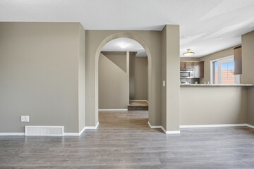 Large open living room with a white wall