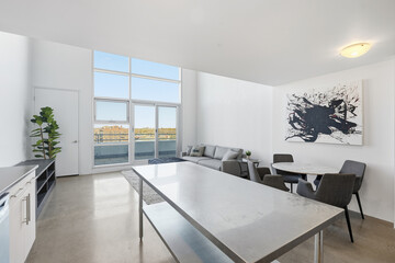 Large open living room with a white table and chairs