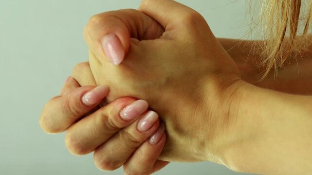 Female hands pressing together and making vacuum clapping sound, playful gesture close-up.