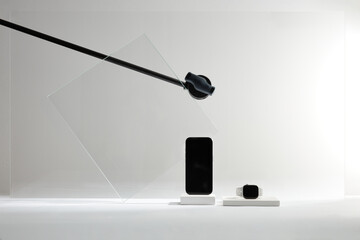Mockup Modern devices: Smartphone and smartwatch display on pedestals, set against a minimalist...