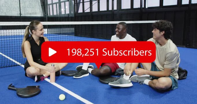 Teammates seated courtside spotting social media subscriber count updating and celebrating growth