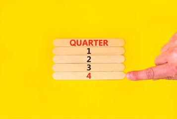 4th fourth quarter 4 symbol. Concept word Quarter 4 on beautiful wooden sticks. Beautiful yellow...