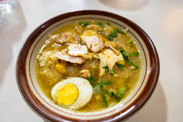 Soto ayam,  a traditional Indonesian dish, in street food restaurant. Soto ayam is also popular in Singapore and Malaysia