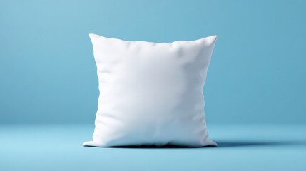 Cozy Cushion: The plush white cushion stands alone, providing a clean and inviting aesthetic. Ideal for comfort or design with a calming blue backdrop.