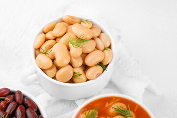 Kidney, butter and baked beans in bowls on towel for protein food, clean eating or vegan variety concept