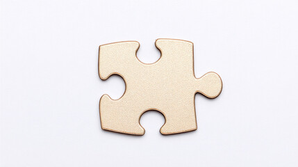 Golden wooden puzzle piece on white background with soft shadow suggesting simplicity and play