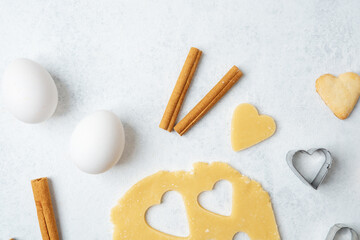 Heart shaped cookies with cinnamon and raw dough for baking or valentines day concept
