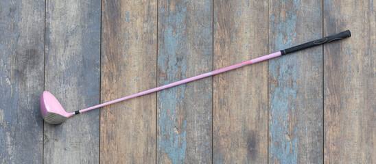 pink golf club on wooden background