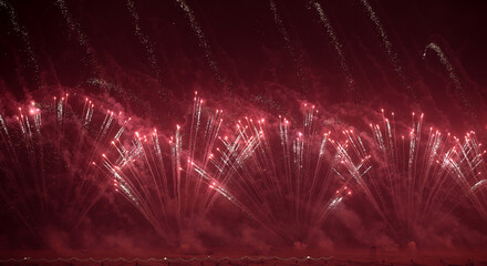 A beautiful fireworks with red spark trails creating a radiant overlay effect. Perfect for celebration posters and festive visuals.