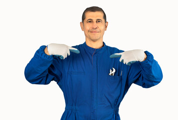 Middle age handsome man wearing mechanic blue uniform looking confident with smile on face, pointing oneself with fingers proud and happy