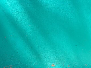 An abstract blue background. A teal green wall.