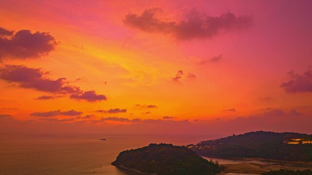 
Aerial hyperlapse view of Crimson Clouds Floating Above the island, romantic glow over the horizon. Serene Paradise Sunset by the Sea at Kala island Layan beach. Colorful Evening Glow by the Beach