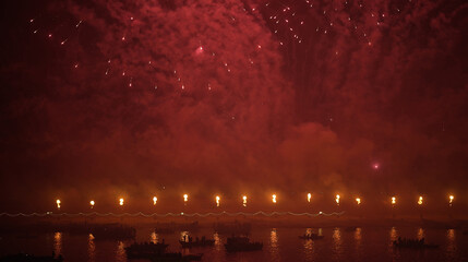 A powerful burst of red fireworks lights up the night sky above the Ganga River during Dev Deepawali in Varanasi.
