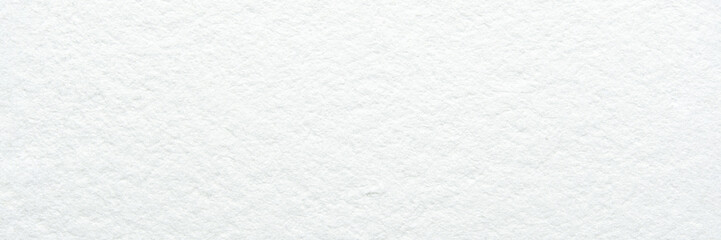 Close-up of textured white paper background with subtle patterns and soft lighting.