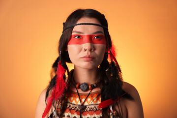 Shaman woman with face painting on orange gradient background