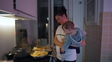 Mother cooking with baby watching food in pan, warm family moment showing curiosity, care, and everyday rhythm of parenthood and home life