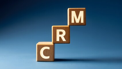 Wooden blocks spelling CRM Customer Relationship Management for business growth and success in marketing strategies