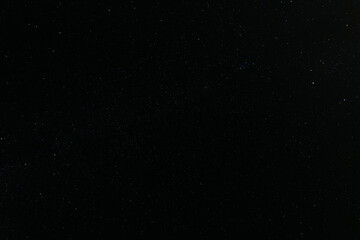 A breathtaking view of the star-filled night sky, showcasing countless stars and a faint band of the Milky Way stretching across the darkness.