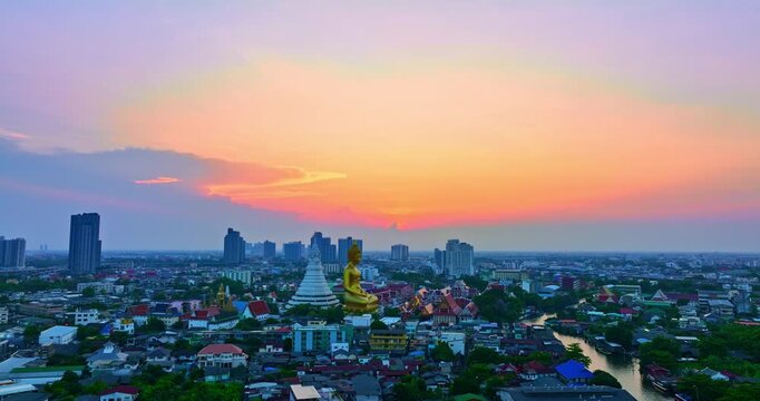 aerial view golden big Buddha Wat Paknam Phasi Charoen in sunset. 
beautiful sunset reflection on a canal in front big buddha. 
scenery sky in twilight background.the one famous landmarks in Thailand.