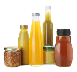 Bottles and jars with different tasty sauces isolated on white