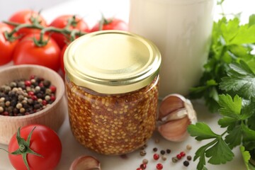 Bottles of different tasty sauces and products on white table, closeup
