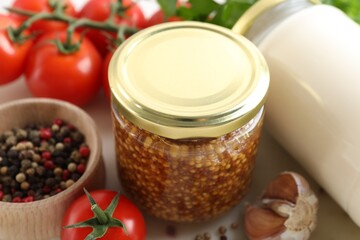 Bottles of different tasty sauces and products on white table, closeup