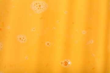 Texture of beaten eggs as background, top view