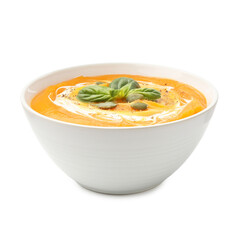 Delicious pumpkin cream soup with basil and seeds isolated on white
