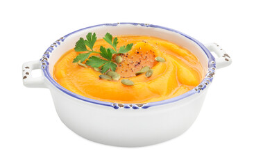Delicious pumpkin cream soup with parsley and seeds isolated on white