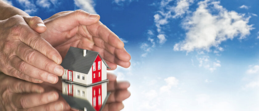 Hands encircling model house—symbolizing protection, care, and the primal rhythm of shelter and emotional grounding.