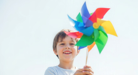 Young boy holding blue recycling bin filled with plastic waste  