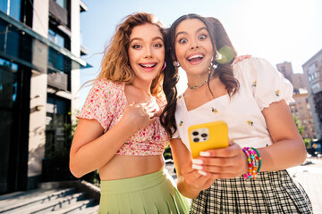 Two best friends on a sunny city street capturing joy fashion and travel vibes