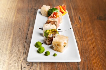 Tasty fresh sushi roll with ingredients and fish