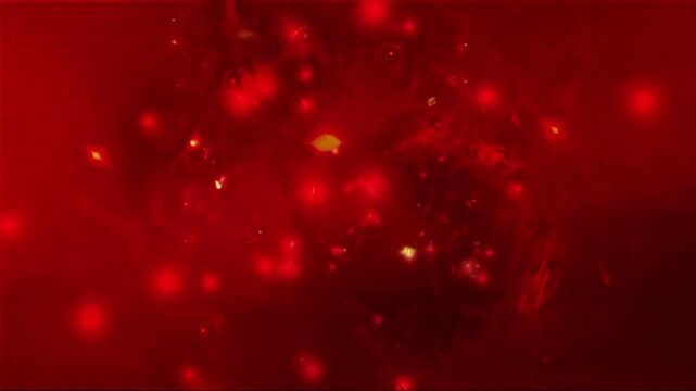 Spinning red abstract particles floating and glowing with soft bokeh effect
