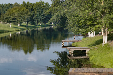 Fishing bridge by the lake. Wooden bridge on the lake. Fishing bridge