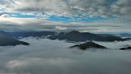 Aerial view of clouds and mountains at sunrise