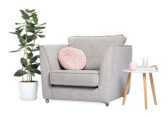 Comfortable armchair, side table and green houseplant on white background