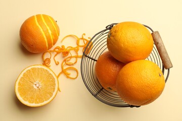 Orange zest and fresh fruits on beige background, flat lay