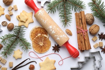 Christmas composition with fir tree branches, cookies and spices on white background, flat lay