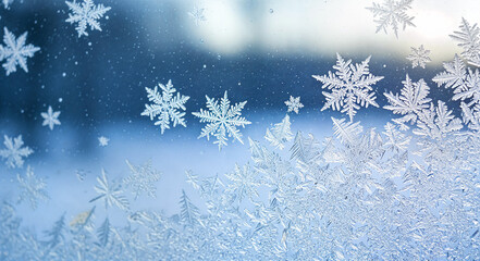 Frosty snowflakes on glass surface creating winter background  