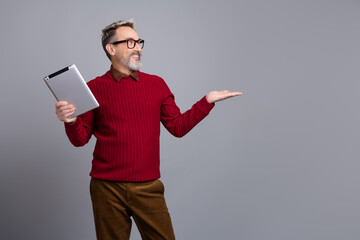 Professional mature man presenting with tablet, showcasing business opportunities and career...