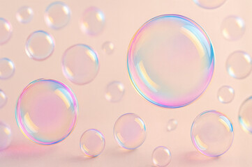 Iridescent soap bubbles on pastel background