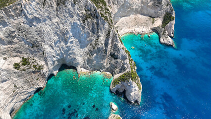 Aerial drone photo of paradise volcanic island white cliffs with limestone trees forming sea caves...