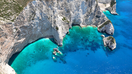 Aerial drone photo of white beach consisting of volcanic caves and white steep hill near famous...